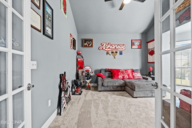 living area featuring ceiling fan, french doors, carpet, and lofted ceiling