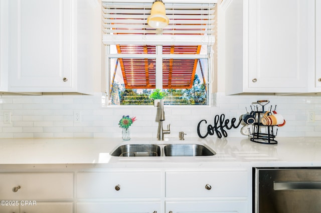 kitchen with white cabinetry, backsplash, dishwasher, and sink