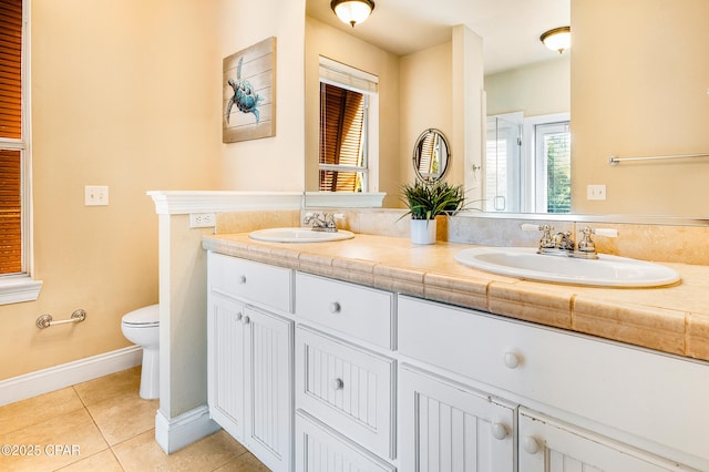 bathroom featuring tile patterned flooring, vanity, and toilet