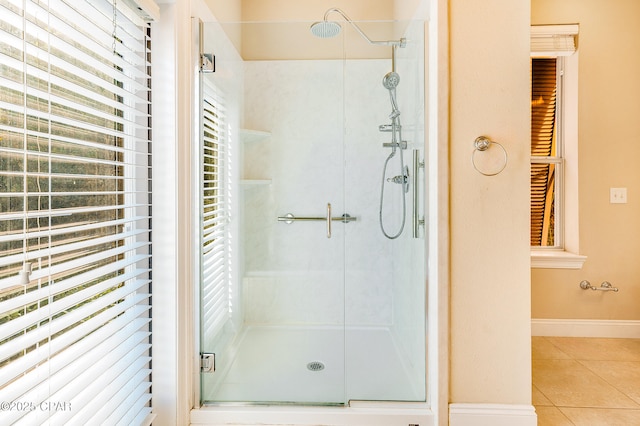 bathroom featuring tile patterned flooring and a shower with shower door