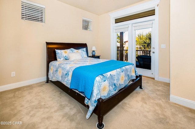 bedroom with access to exterior and light colored carpet