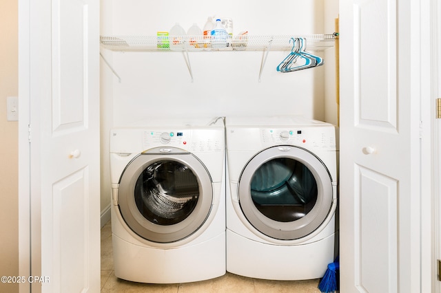 washroom with separate washer and dryer and light tile patterned floors