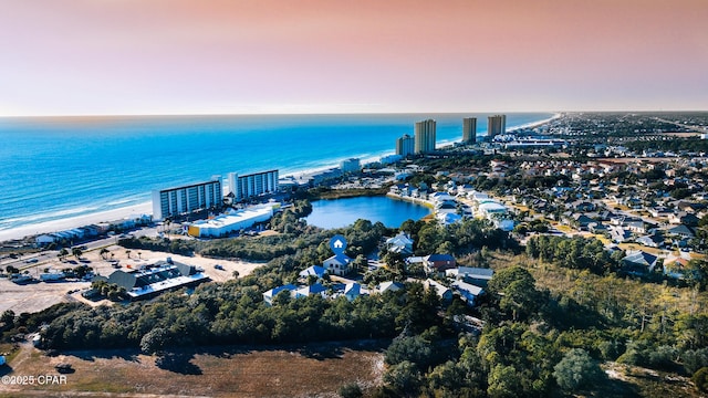 aerial view at dusk featuring a water view