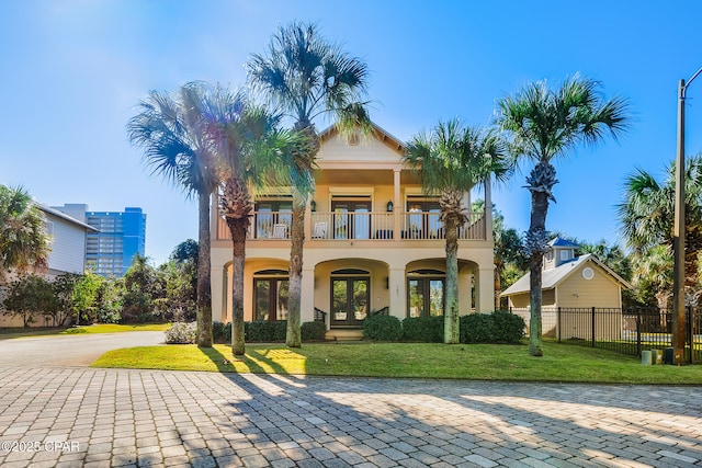 back of property featuring a yard and a balcony