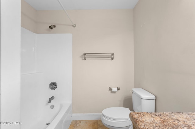 bathroom featuring tile patterned floors, toilet, and bathing tub / shower combination