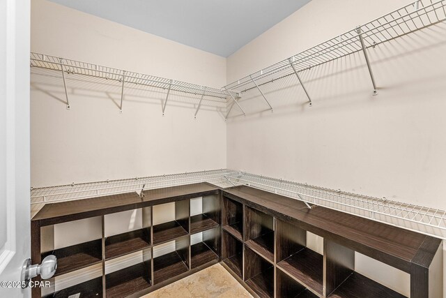 spare room featuring light tile patterned floors, vaulted ceiling, and ceiling fan