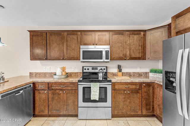 kitchen featuring a notable chandelier, dark brown cabinets, pendant lighting, and a wealth of natural light