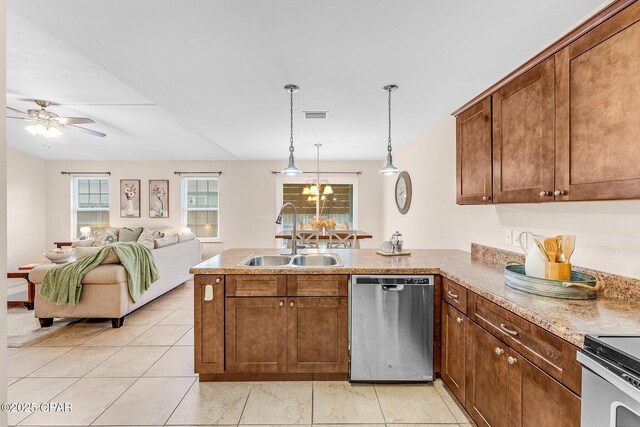 kitchen featuring sink, dark brown cabinetry, stainless steel appliances, and hanging light fixtures