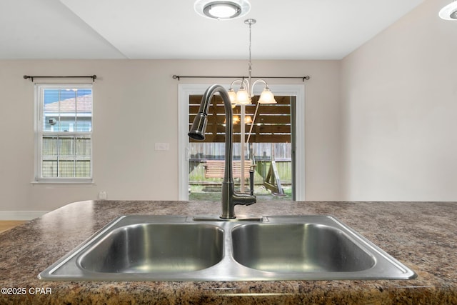 interior details featuring sink, a chandelier, and decorative light fixtures