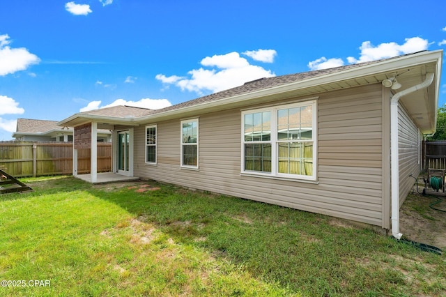 rear view of property featuring a yard