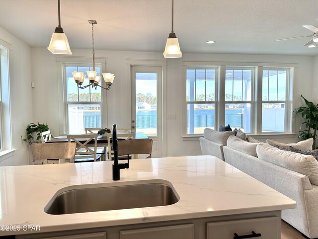 kitchen featuring light hardwood / wood-style floors, decorative backsplash, sink, stainless steel appliances, and light stone counters