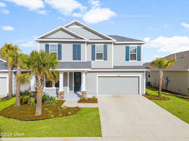 view of front facade featuring a front lawn, central air condition unit, and a garage