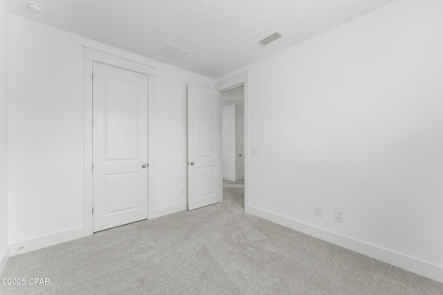 unfurnished bedroom with light colored carpet