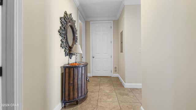 hallway featuring light tile patterned floors, ornamental molding, and electric panel