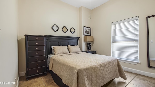 tiled bedroom with lofted ceiling