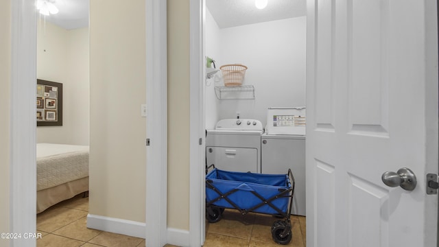 bathroom with washer and dryer, a textured ceiling, and tile patterned floors