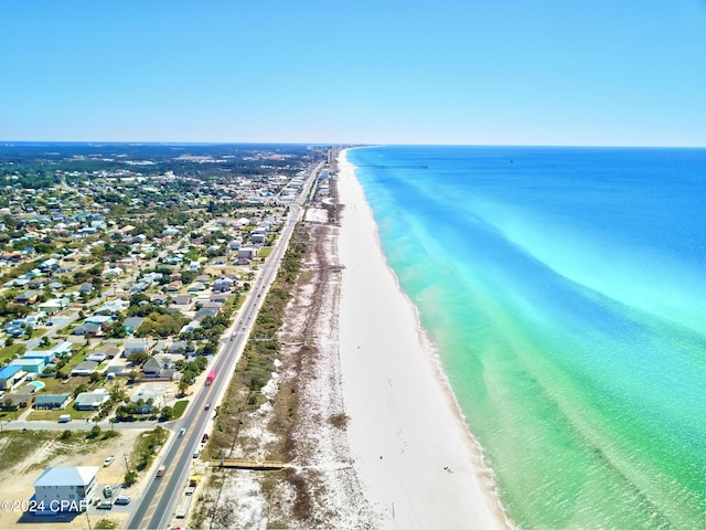 birds eye view of property with a water view and a beach view