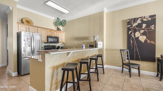 kitchen featuring kitchen peninsula, crown molding, a breakfast bar area, light tile patterned floors, and black appliances