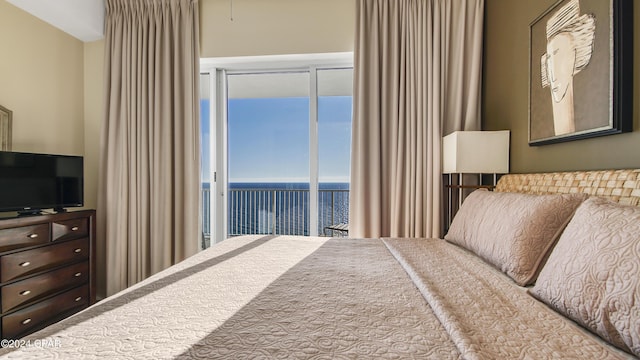 bedroom featuring access to exterior and a water view