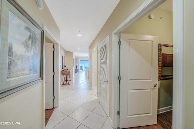 hallway with light tile patterned floors