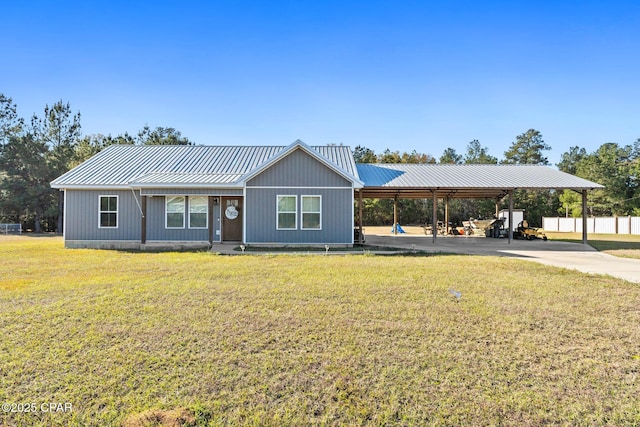 ranch-style house featuring a carport and a front lawn