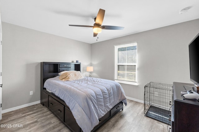 bedroom featuring light hardwood / wood-style floors and ceiling fan