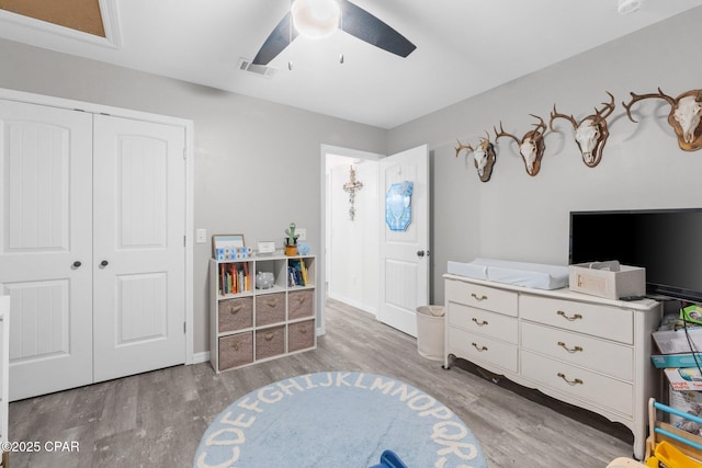 living area featuring ceiling fan and light hardwood / wood-style flooring