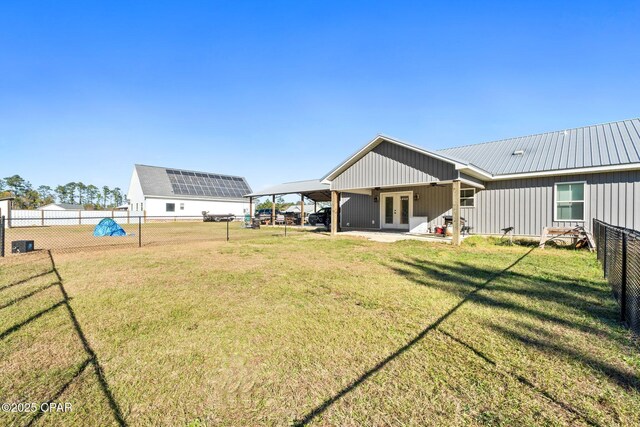 view of yard with french doors and a carport