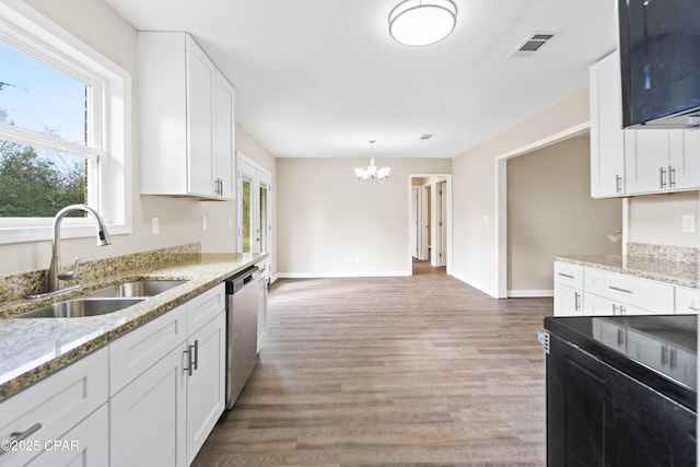 kitchen featuring an inviting chandelier, white cabinets, sink, stainless steel dishwasher, and light stone countertops