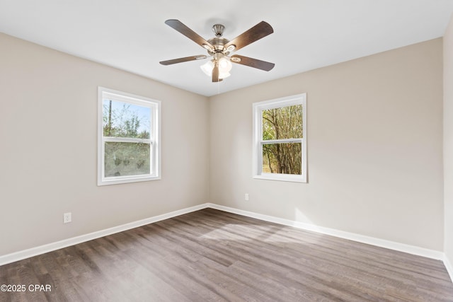 unfurnished room with ceiling fan, a healthy amount of sunlight, and dark hardwood / wood-style flooring