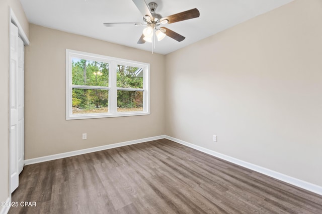 unfurnished bedroom featuring ceiling fan, a closet, and wood-type flooring