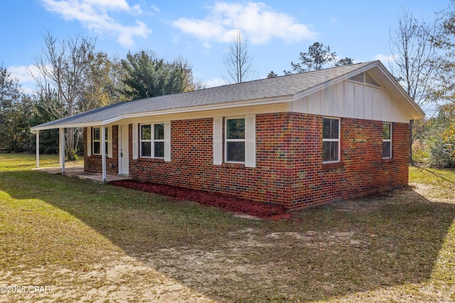 view of side of home with a yard and a porch