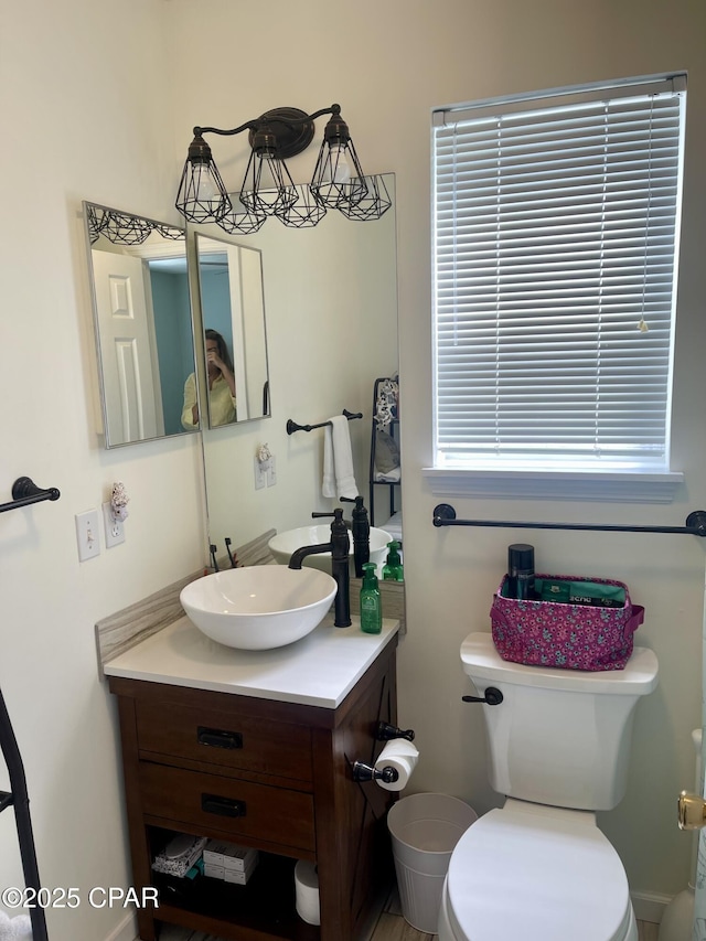 bathroom featuring vanity and toilet