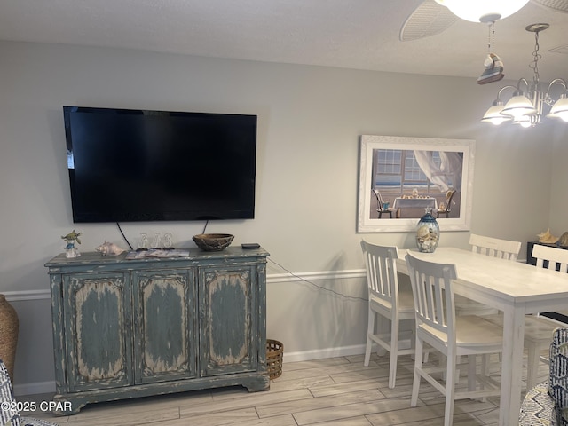 dining area with a chandelier and light hardwood / wood-style floors