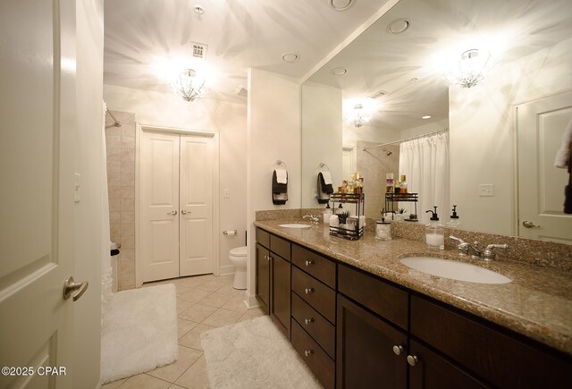 bathroom featuring toilet, tile patterned flooring, a shower with curtain, and vanity