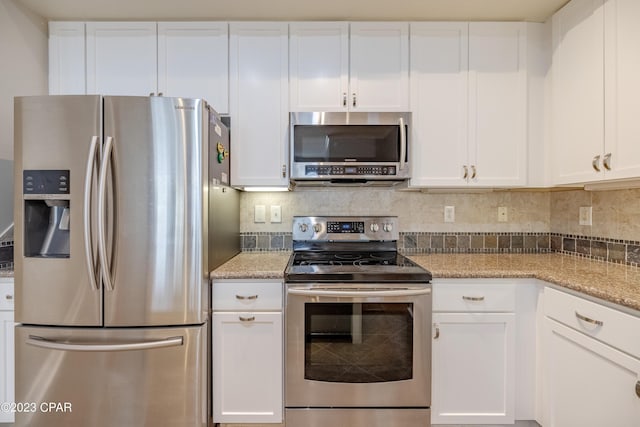 kitchen featuring white cabinets, appliances with stainless steel finishes, and light stone countertops