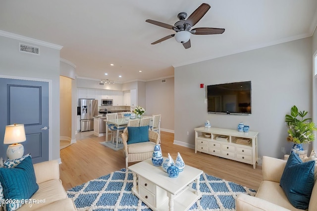 living room featuring ceiling fan, light hardwood / wood-style floors, and ornamental molding