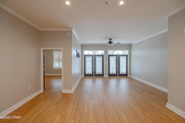 unfurnished room with ceiling fan, light hardwood / wood-style floors, ornamental molding, and french doors