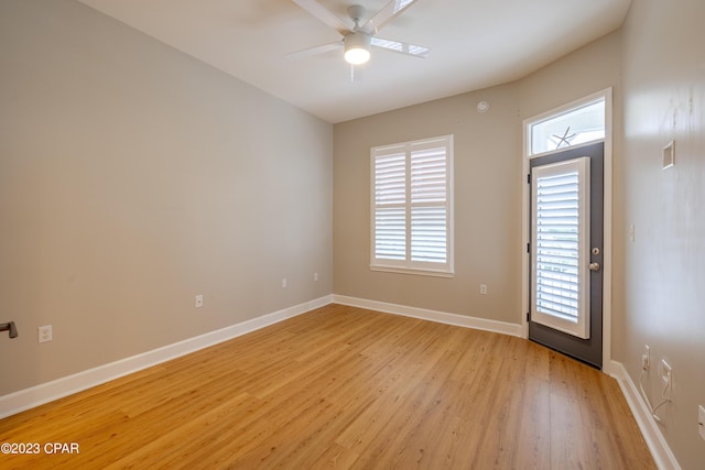 empty room with ceiling fan and light wood-type flooring