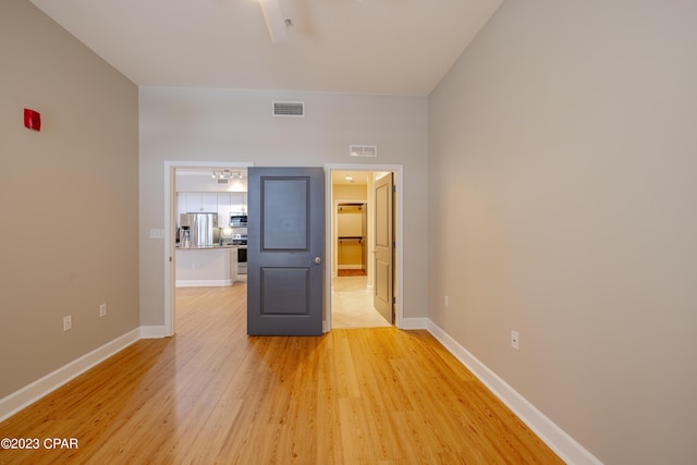 spare room featuring light hardwood / wood-style floors