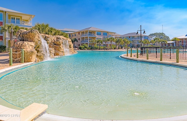 view of swimming pool with pool water feature