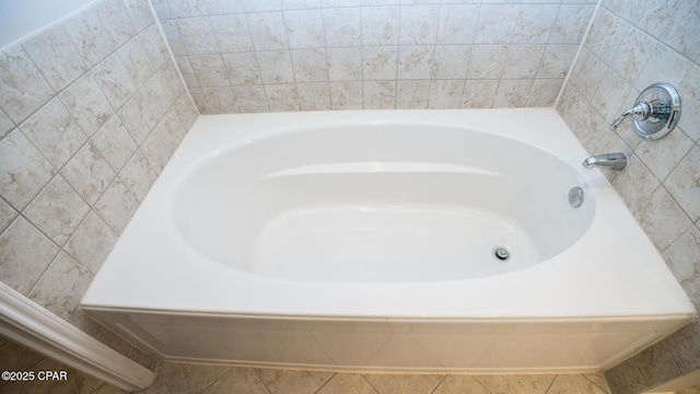 bathroom with a tub to relax in