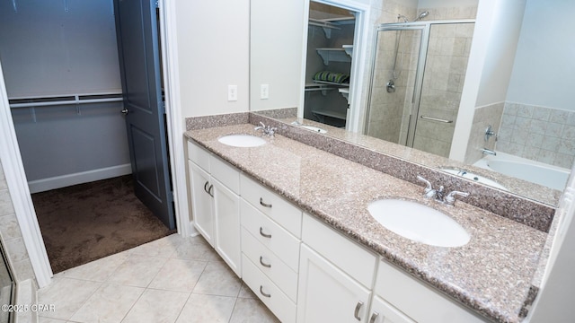 bathroom featuring tile patterned floors, separate shower and tub, and vanity