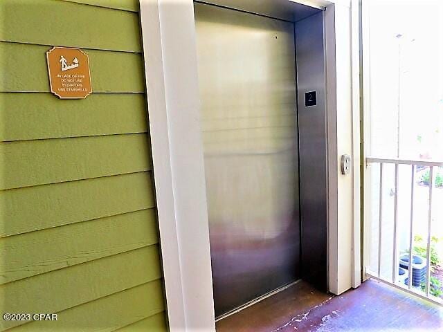 room details with elevator and wood walls