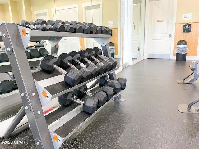 gym featuring wood walls