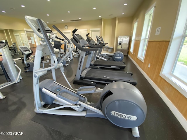 exercise room with wooden walls