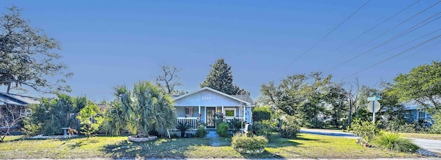 bungalow with a porch and a front yard