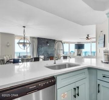 kitchen with dishwasher, decorative light fixtures, ceiling fan with notable chandelier, and sink