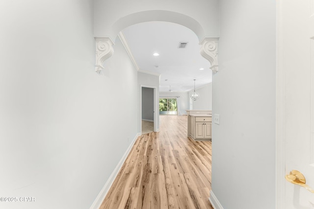 corridor featuring light hardwood / wood-style flooring and ornamental molding