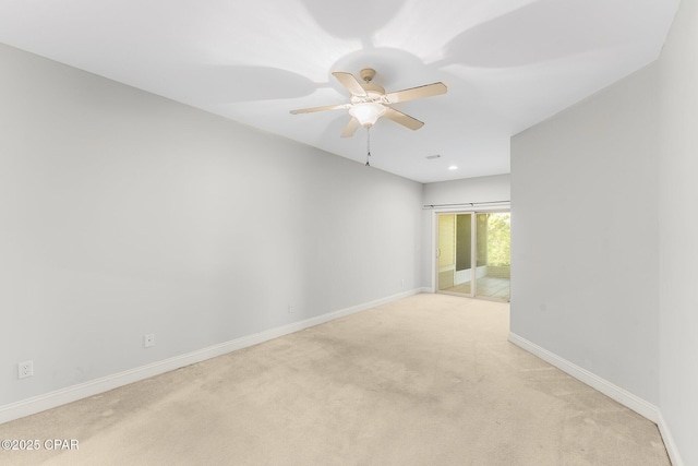 carpeted empty room featuring ceiling fan